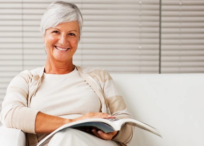 Senior woman enjoying reading the magazine